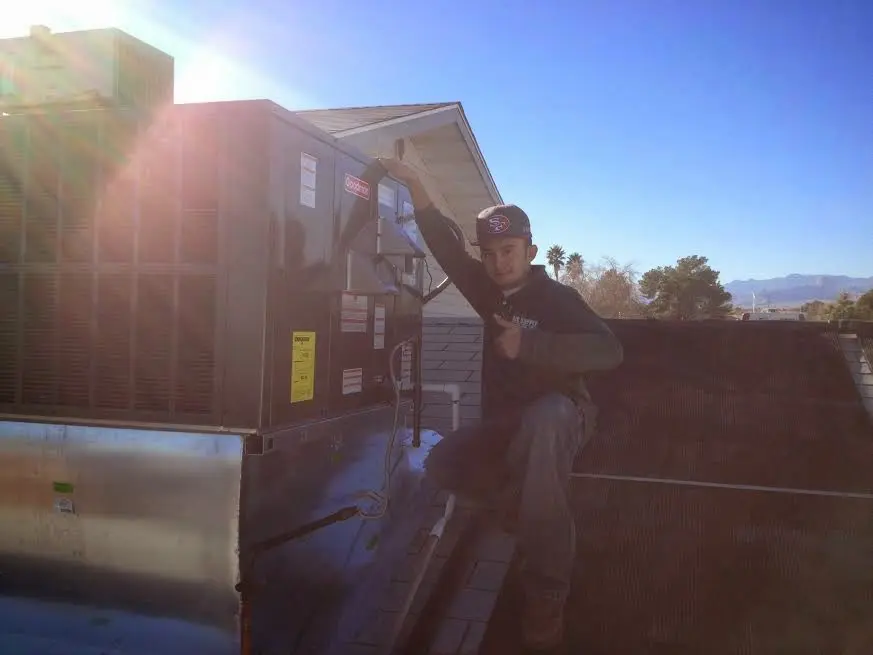 HVAC technician performing HVAC Inspection on a rooftop unit in San Gabriel